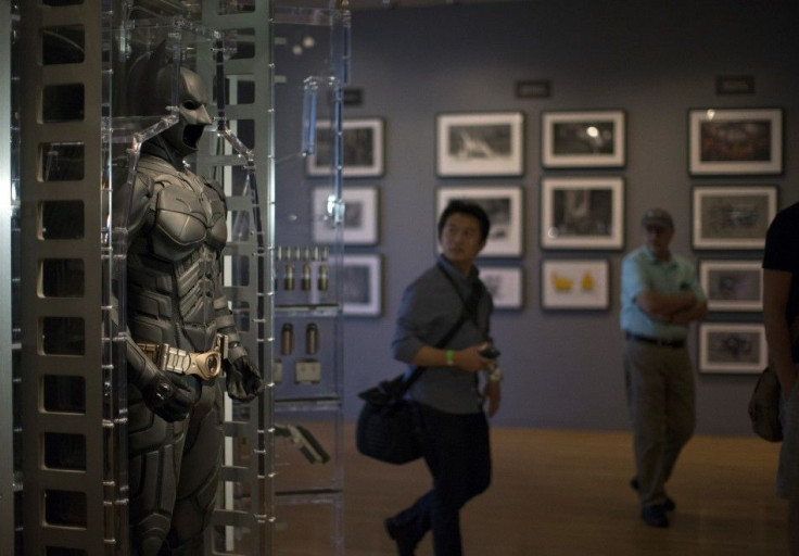Men look at a Batman suit during a media preview of the Warner Bros. VIP Studio Tour