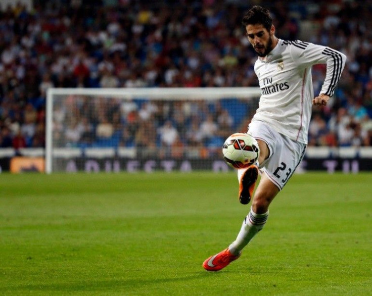 Real Madrid's Isco controls the ball during their Spanish first division soccer match against Elche at Santiago Bernabeu stadium in Madrid September 23, 2014.