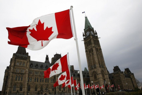 Canadian flags line the road around Parliament Hill during the National Day of Honour ceremony in Ottawa May 9, 2014. 