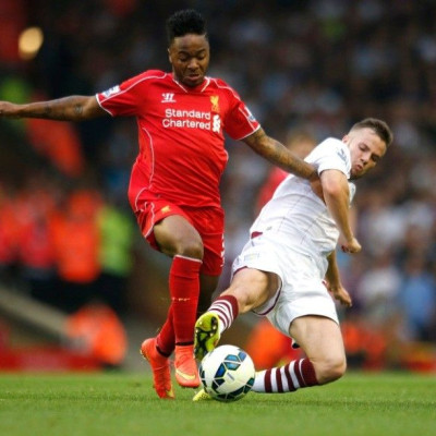 Liverpool's Raheem Sterling (L) challenges Aston Villa's Tom Cleverley during their English Premier League soccer match at Anfield in Liverpool, northern England September 13, 2014.