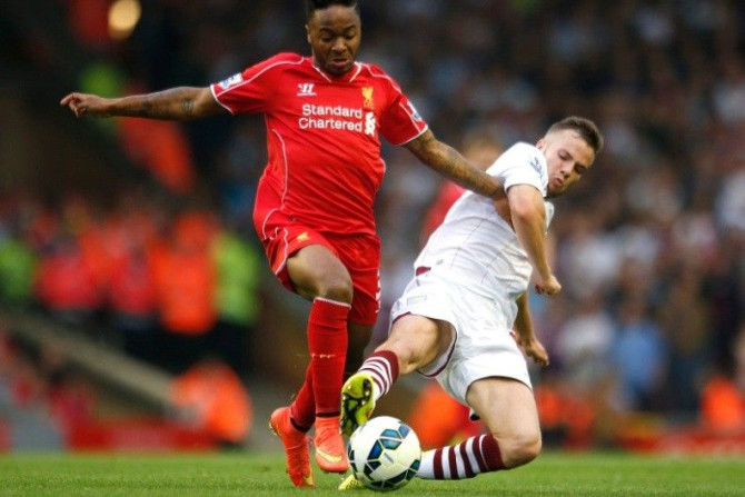 Liverpool's Raheem Sterling (L) challenges Aston Villa's Tom Cleverley during their English Premier League soccer match at Anfield in Liverpool, northern England September 13, 2014.