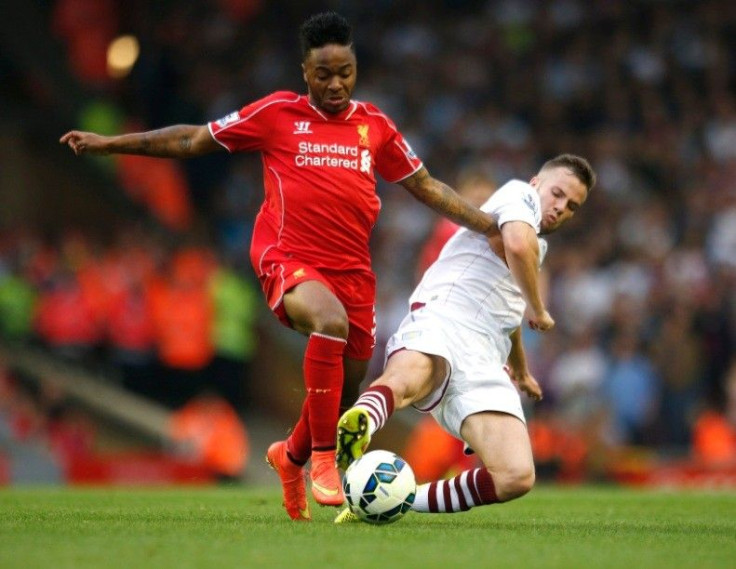 Liverpool's Raheem Sterling (L) challenges Aston Villa's Tom Cleverley during their English Premier League soccer match at Anfield in Liverpool, northern England September 13, 2014.