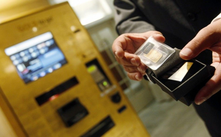 Ex Oriente Lux CEO Thomas Geissler holds a gold bar after unveiling the first gold-plated ATM (automated teller machine) in Europe, at a Madrid's luxury hotel September 23, 2010. The machine, which features cutting-edge technology, dispenses 1g, 5g a