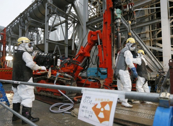 Workers conduct operations to construct an underground ice wall at Tokyo Electric Power Co.&#039;s (Tepco) tsunami-crippled Fukushima Daiichi nuclear power plant in Fukushima Prefecture July 9, 2014. The media were shown on Tuesday the site where Tepco is