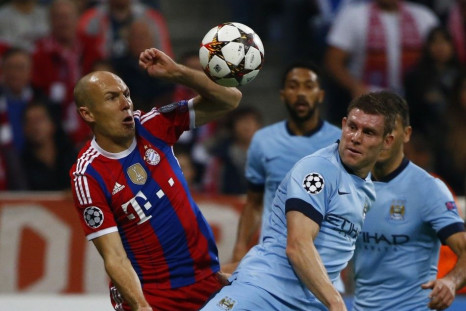 Bayern Munich's Arjen Robben challenges Manchester City's James Milner (R) during their Champions League group E soccer match in Munich September 17, 2014.