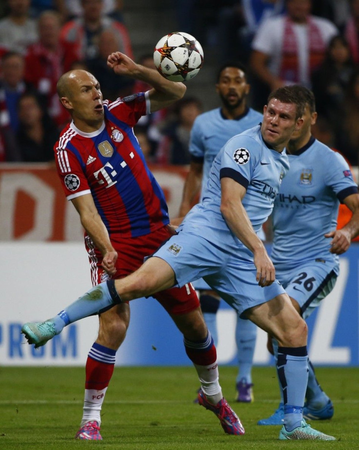 Bayern Munich's Arjen Robben challenges Manchester City's James Milner (R) during their Champions League group E soccer match in Munich September 17, 2014.