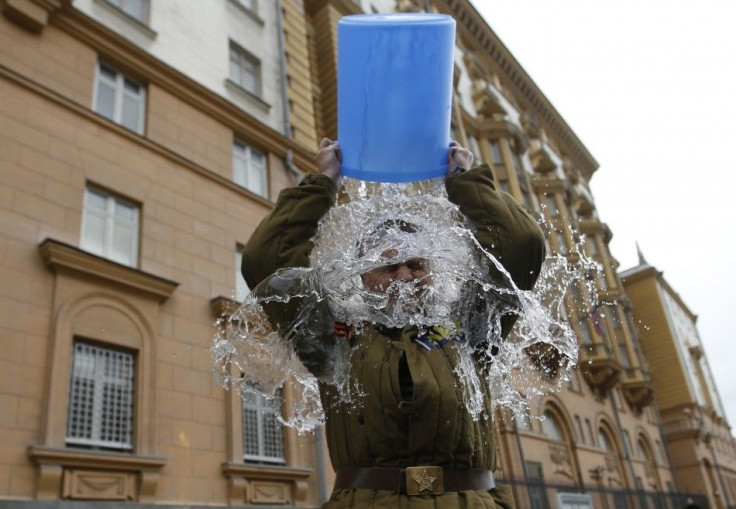 Alexei Didenko, a deputy for the Russian State Duma, dumps a bucket of cold water on himself