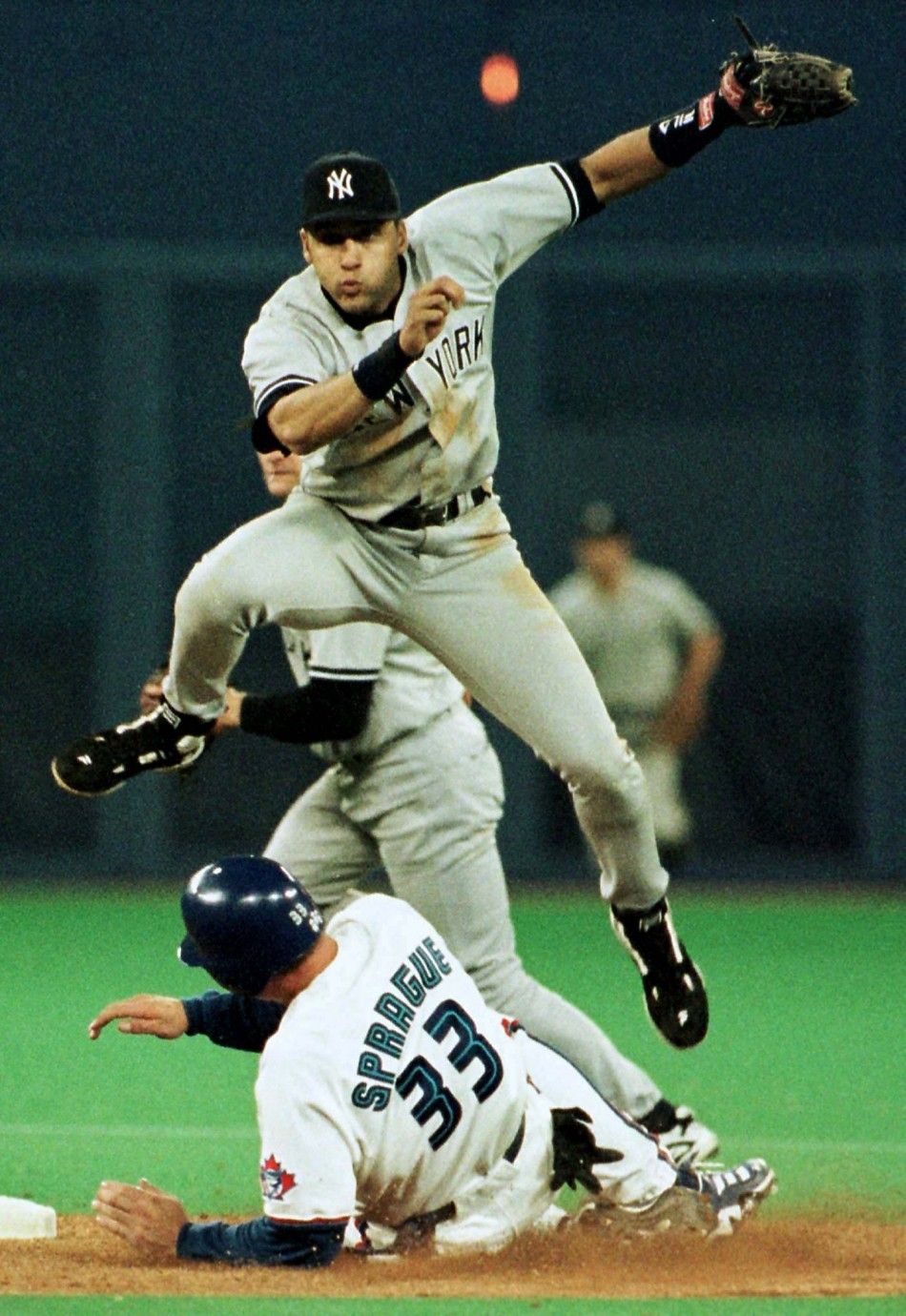 New York Yankees shortstop Derek Jeter jumps out of the way