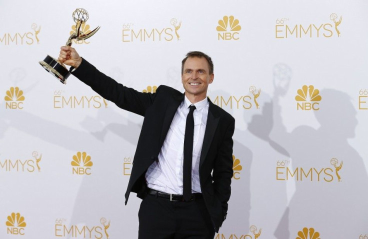 Phil Keoghan poses with his Outstanding Reality-Competition Program award for the CBS show &quot;The Amazing Race&quot; at the 66th Primetime Emmy Awards in Los Angeles, California August 25, 2014.