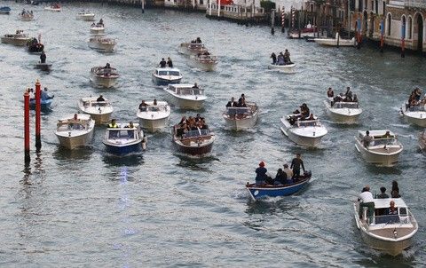 U.S. actor George Clooney travels in a taxi boat C in the Grand Canal in Venice, ahead of a gala dinner September 27, 2014.
