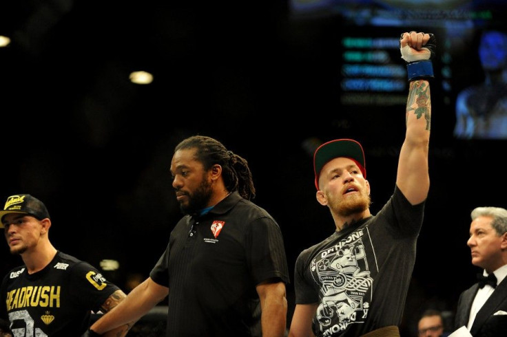 Sep 27, 2014; Las Vegas, NV, USA; Conor McGregor (blue gloves) is victorious over Dustin Poirier during a featherweight fight during UFC 178 at MGM Grand Garden Arena.