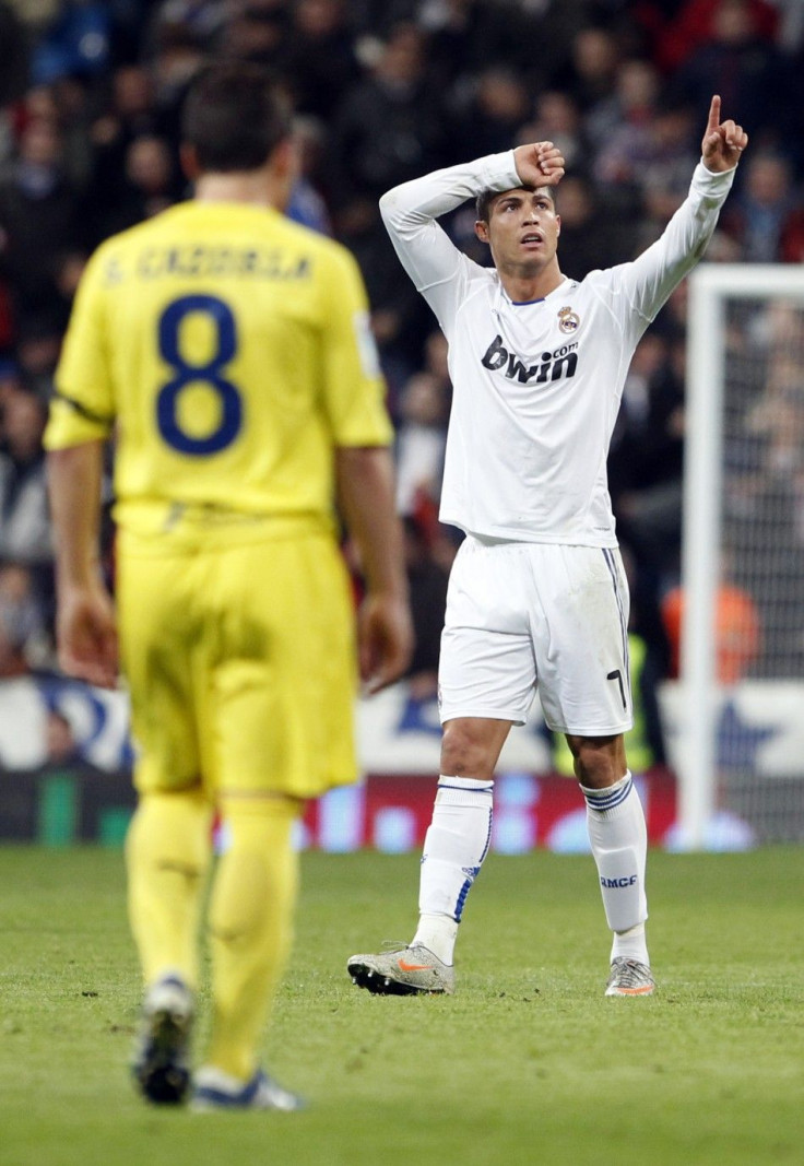 Real Madrid's Cristiano Ronaldo (R) celebrates his goal during their Spanish first division soccer league match against Villareal at the Santiago Bernabeu stadium in Madrid,January 9, 2011.