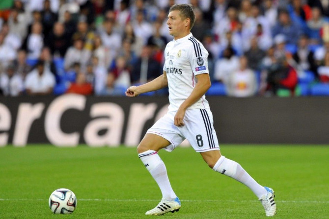 Real Madrid's Toni Kroos controls the ball during the UEFA Super Cup final soccer match against Sevilla at Cardiff City stadium, Wales, August 12, 2014.