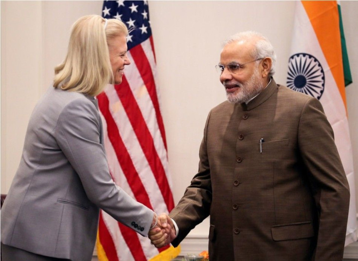 Indian Prime Minister Narendra Modi (R) shakes hands with Ginni Rometty