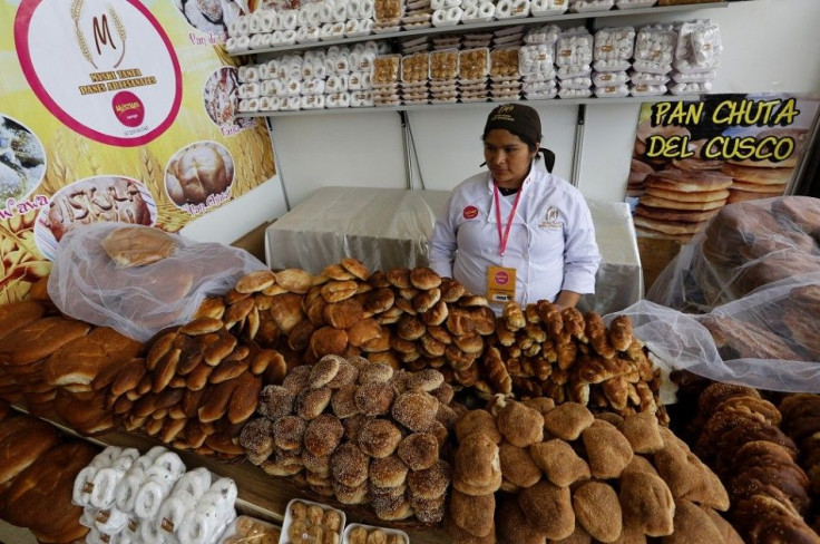 baker sells bread during the Mistura gastronomic fair in Lima, September 5, 2014. The fair seeks to promote Peruvian cuisine by showcasing food and products from all over the country. Exponents of Peruvian cuisine and foreign chefs are also participating 