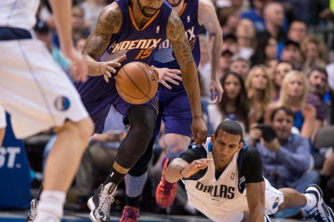 Apr 12, 2014; Dallas, TX, USA; Phoenix Suns forward Marcus Morris (15) steals the ball from Dallas Mavericks forward Brandan Wright (34) during the first half at the American Airlines Center.