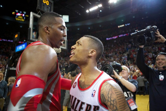 May 2, 2014; Portland, OR, USA;Houston Rockets center Dwight Howard (12) congratulates Portland Trail Blazers guard Damian Lillard (0) after making a last second shot in the second half in game six of the first round of the 2014 NBA Playoffs at the Moda C