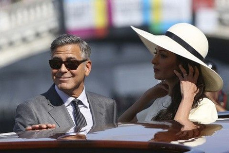 U.S. actor George Clooney and his wife Amal Alamuddin arrive at Venice city hall 