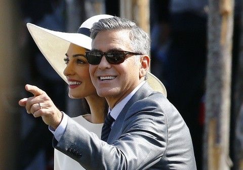 U.S. actor George Clooney and his wife Amal Alamuddin leave Venice city hall after a civil ceremony to formalize their wedding