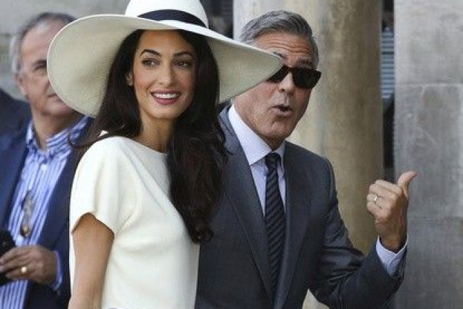U.S. actor George Clooney and his wife Amal Alamuddin arrive at Venice city hall for a civil ceremony to formalize their wedding
