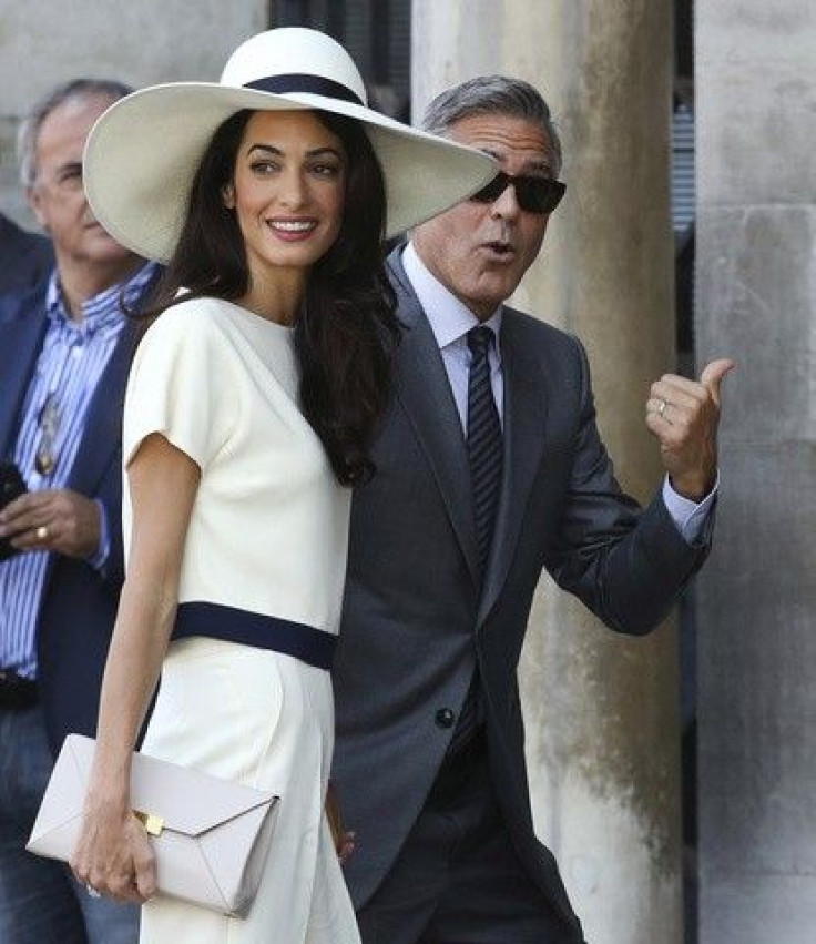 U.S. actor George Clooney and his wife Amal Alamuddin arrive at Venice city hall for a civil ceremony to formalize their wedding