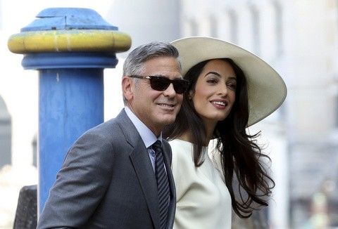 U.S. actor George Clooney and his wife Amal Alamuddin arrive at Venice city hall for a civil ceremony