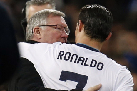 Manchester United's manager Sir Alex Ferguson (L) speaks to Real Madrid's Cristiano Ronaldo after their Champions League soccer match at Santiago Bernabeu stadium in Madrid, February 13, 2013.