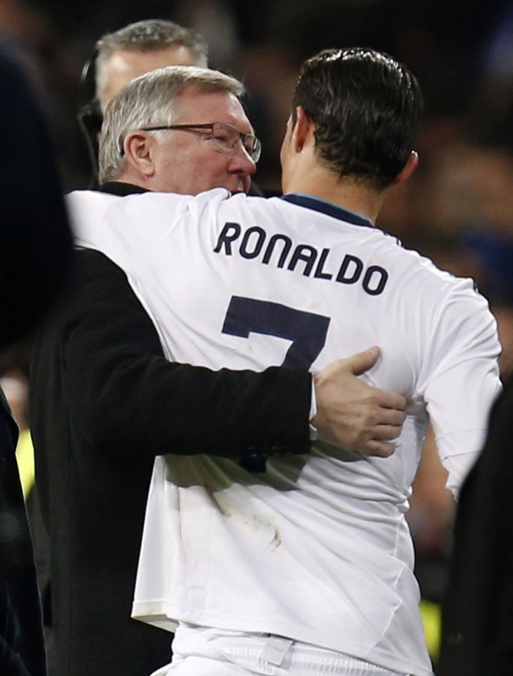 Manchester United's manager Sir Alex Ferguson (L) speaks to Real Madrid's Cristiano Ronaldo after their Champions League soccer match at Santiago Bernabeu stadium in Madrid, February 13, 2013.