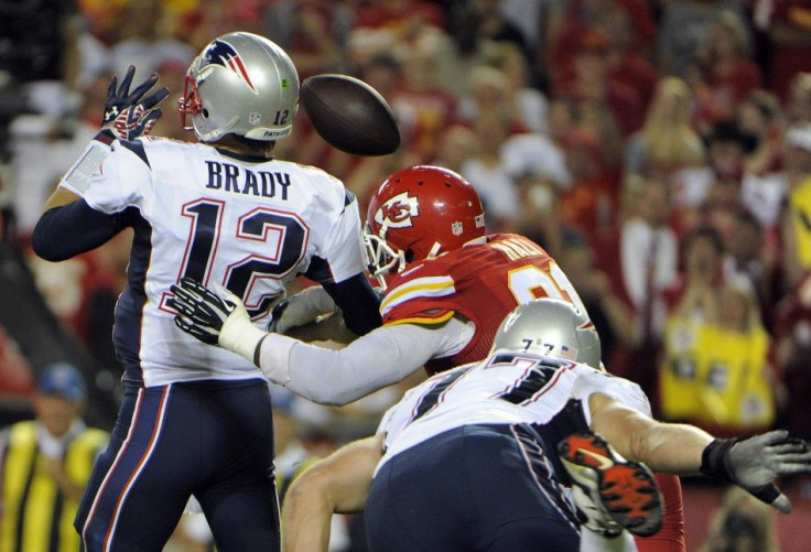 Kansas City Chiefs outside linebacker Tamba Hali causes a fumble from New England Patriots quarterback Tom Brady