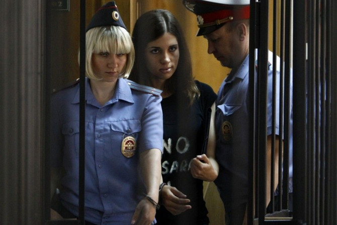 Member of the female punk band &quot;Pussy Riot&quot; Nadezhda Tolokonnikova (C) is escorted before a court hearing to appeal for parole at the Supreme Court of Mordovia in Saransk, July 26, 2013. Tolokonnikova was sentenced to two years in prison for the