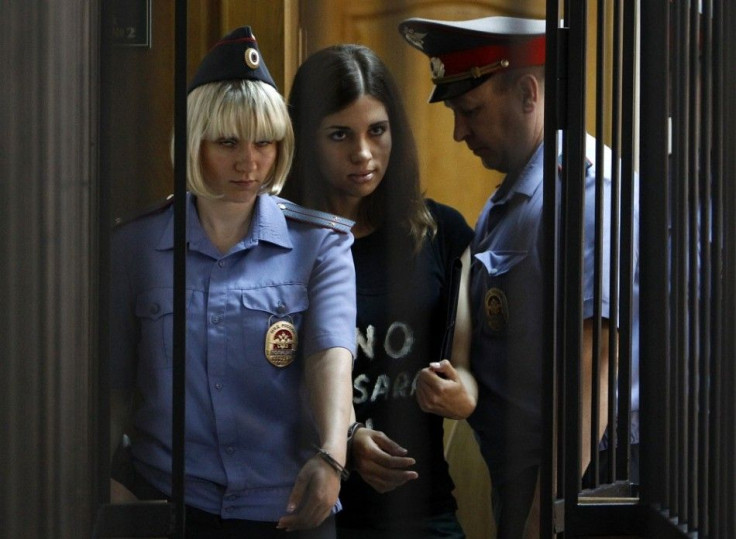 Member of the female punk band &quot;Pussy Riot&quot; Nadezhda Tolokonnikova (C) is escorted before a court hearing to appeal for parole at the Supreme Court of Mordovia in Saransk, July 26, 2013. Tolokonnikova was sentenced to two years in prison for the