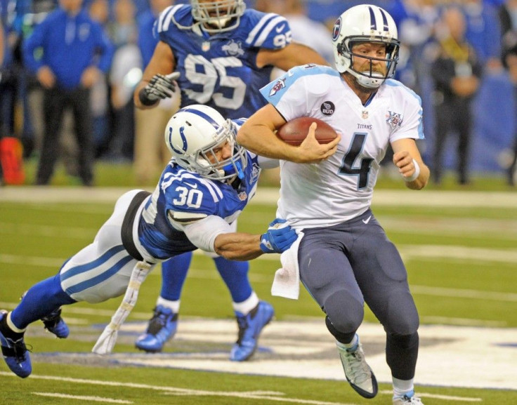 Tennessee Titans quarterback Ryan Fitzpatrick is tackled by the Indianapolis Colts safety LaRon Landry