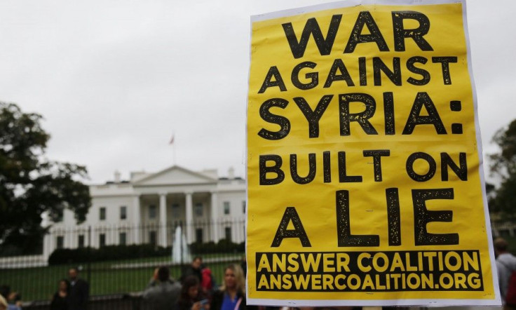 Protesters from the activist group ANSWER (Act Now to Stop War and End Racism) rally against U.S. bombing in Syria in front of the White House in Washington, September 25, 2014. REUTERS/Larry Downing