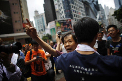 A pro-democracy protester argues with a pro-Beijing demonstrator (not pictured) as people block areas around the government headquarters building in Hong Kong, October 1, 2014. Thousands of pro-democracy protesters thronged the streets of Hong Kong early 