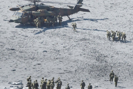 Japan Self-Defense Force (JSDF) soldiers and firefighters conduct rescue operations near the peak of Mt. Ontake, which straddles Nagano and Gifu prefectures, central Japan October 1, 2014, in this photo taken and released by Kyodo. The death toll from Jap