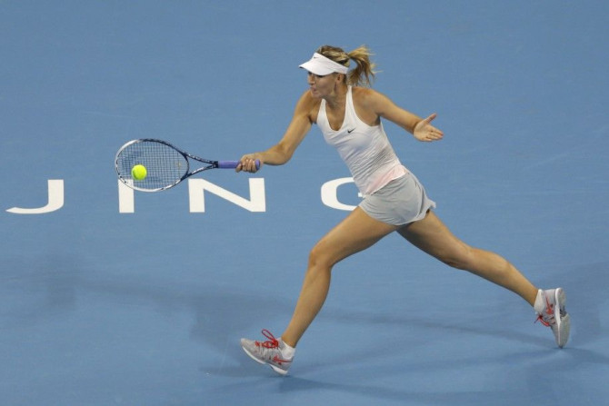 Maria Sharapova of Russia returns the ball during her women&#039;s singles tennis match against Carla Suarez Navarro of Spain at the China Open tennis tournament in Beijing, October 1, 2014. REUTERS/Jason Lee