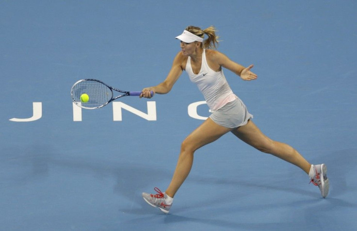 Maria Sharapova of Russia returns the ball during her women&#039;s singles tennis match against Carla Suarez Navarro of Spain at the China Open tennis tournament in Beijing, October 1, 2014. REUTERS/Jason Lee