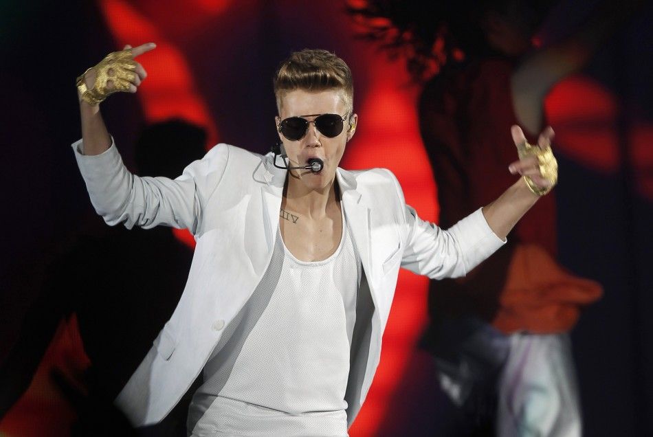Canadian singer Justin Bieber performs during a concert at Palau Sant Jordi stadium in Barcelona in this March 16, 2013 file photo. Bieber has been accused of attempted robbery, a Los Angeles Police Department official said on May 13, 2014, following medi