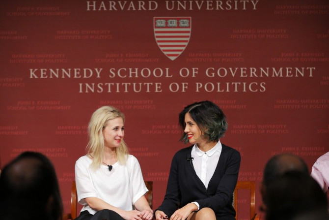 Maria Alyokhina (L) and Nadezhda Tolokonnikova, members of the punk protest band Pussy Riot, take their seats onstage for a forum at the Kennedy School of Government at Harvard University in Cambridge, Massachusetts September 15, 2014. REUTERS/Brian Snyde
