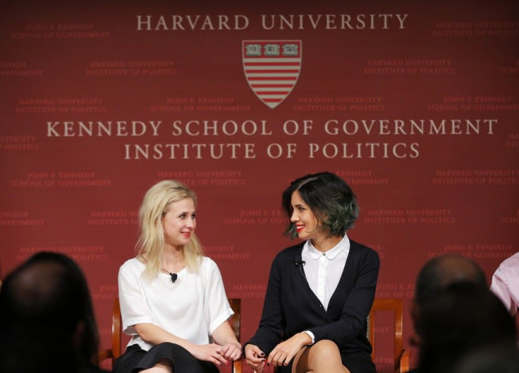 Maria Alyokhina (L) and Nadezhda Tolokonnikova, members of the punk protest band Pussy Riot, take their seats onstage for a forum at the Kennedy School of Government at Harvard University in Cambridge, Massachusetts September 15, 2014. REUTERS/Brian Snyde