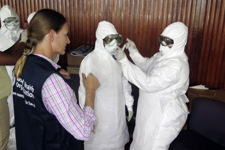 A WHO Health Worker Teaches Trainee Health Workers How To Put On A Protective Suit In Freetown