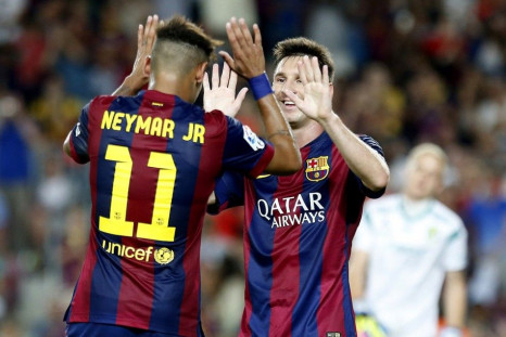 Barcelona's Neymar (L) celebrates his second goal with Lionel Messi against Mexico's club Leon during their Joan Gamper Trophy soccer match at Nou Camp stadium in Barcelona August 18, 2014.