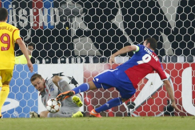 FC Basel's Marco Streller (R) scores a goal against Liverpool's goalkeeper Simon Mignolet during their Champions League Group B match at St. Jakobs-Park stadium in Basel October 1, 2014.