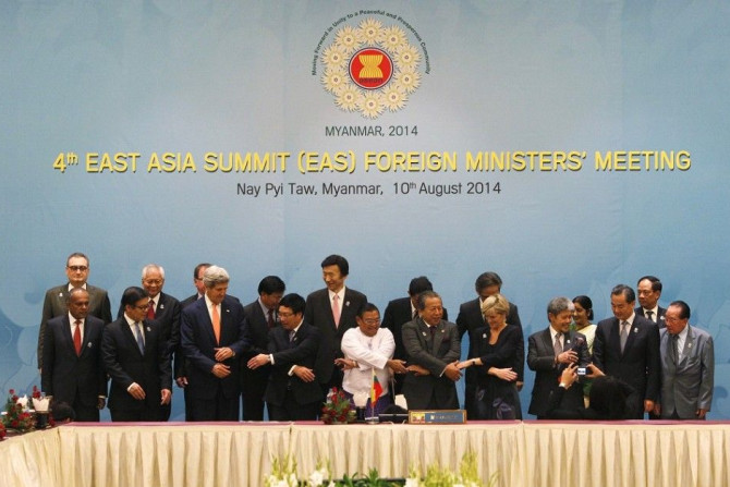 Dignitaries hold hands as they pose for a photo before the 4th East Asia Summit (EAS) Foreign Ministers Meeting at the Myanmar International Convention Centre (MICC) in Naypyitaw, August 10, 2014. Pictured in the front row are (L-R): Singapore's Foreign M