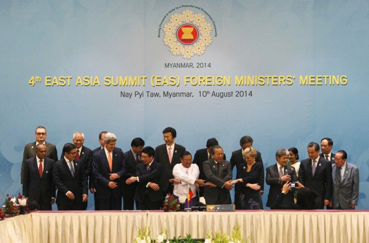 Dignitaries hold hands as they pose for a photo before the 4th East Asia Summit (EAS) Foreign Ministers Meeting at the Myanmar International Convention Centre (MICC) in Naypyitaw, August 10, 2014. Pictured in the front row are (L-R): Singapore's Foreign M