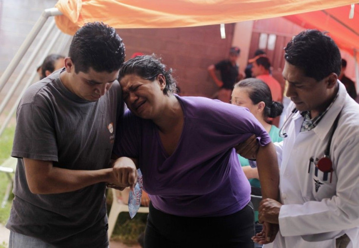 A woman showing chikungunya-like fever symptoms is helped by a doctor