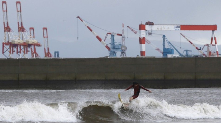 A surfer rides a wave as Typhoon Phanfone passes the area, at a beach in Tsu, Mie prefecture, October 6, 2014. Hundreds of flights were cancelled and thousands of people advised to evacuate as a powerful typhoon lashed Japan on Monday with heavy rains and