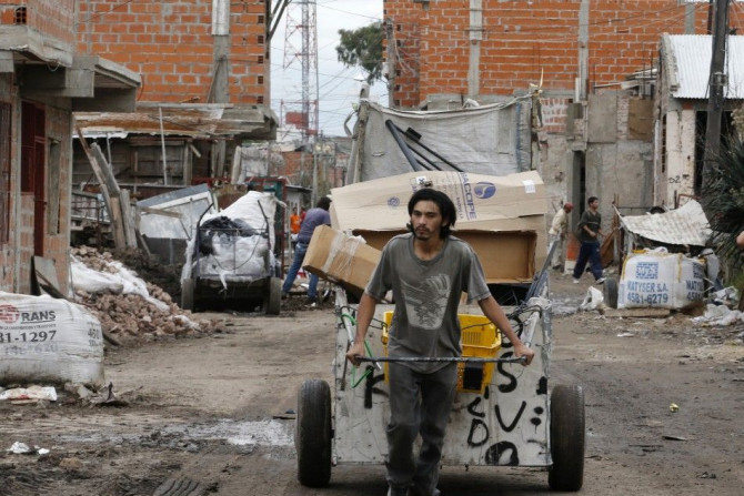 A garbage collector pulls his cart at a shantytown in Buenos Aires May 3, 2014