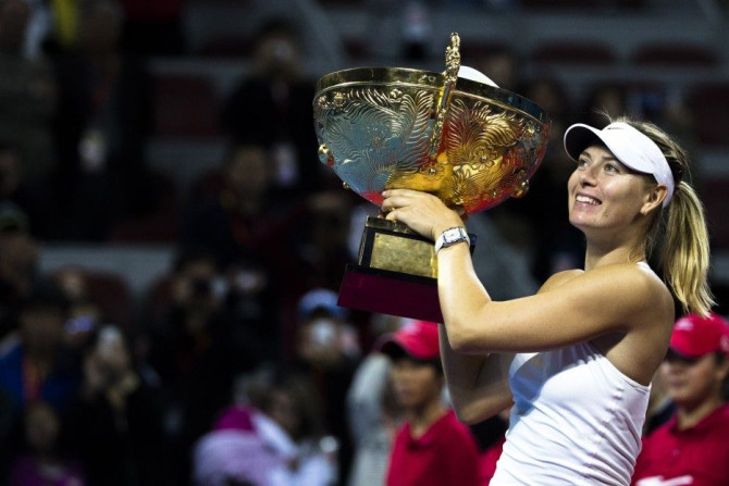 Maria Sharapova of Russia holds her trophy after winning the women&#039;s singles final match against Petra Kvitova of the Czech Republic at the China Open tennis tournament in Beijing October 5, 2014. REUTERS/Stringer