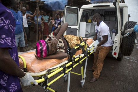 A pregnant woman suspected of contracting Ebola is lifted by stretcher into an ambulance in Freetown, Sierra Leone September 19, 2014 in a handout photo provided by UNICEF. Sierra Leone's army has &quot;sealed off&quot; the borders with Liberia and G